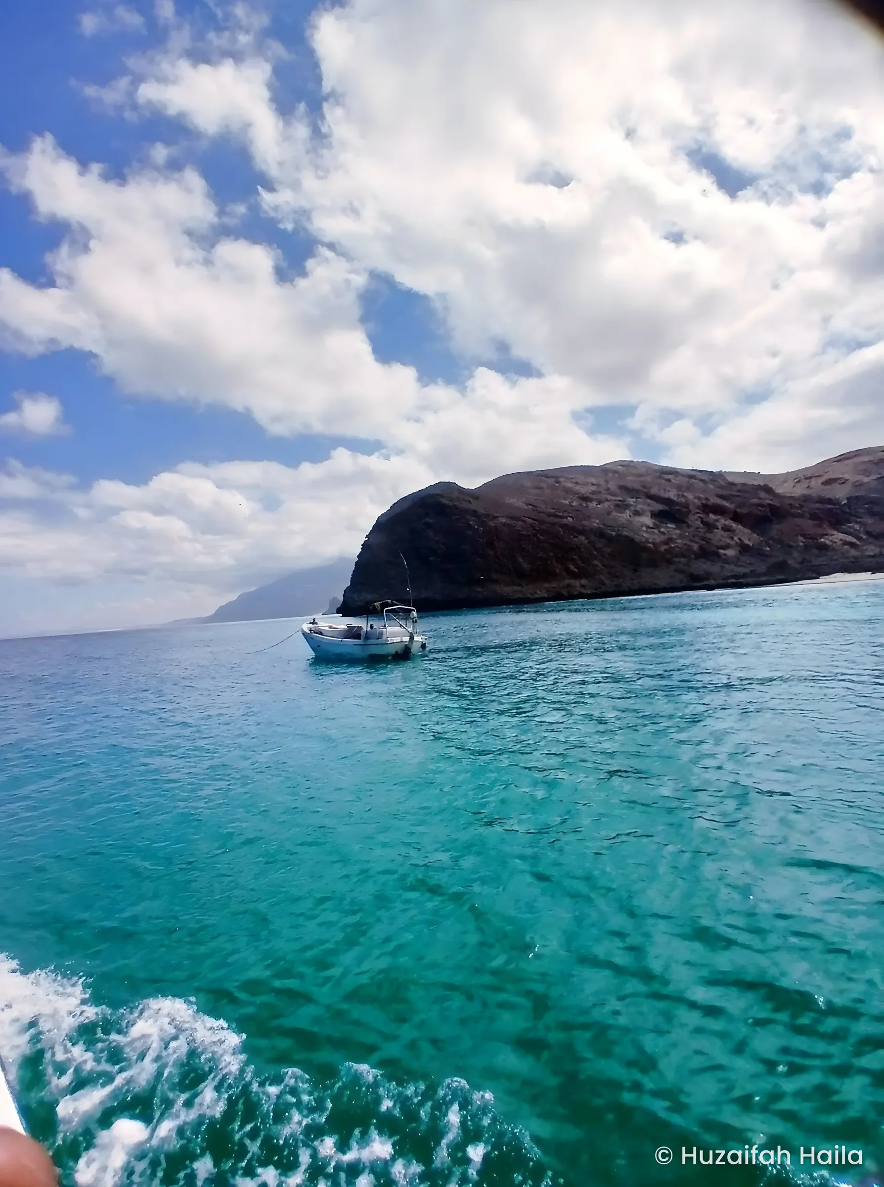 Boat near rocky headland, the Bari region coast, Somalia